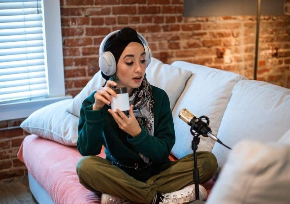 A woman in the process of recording her podcast